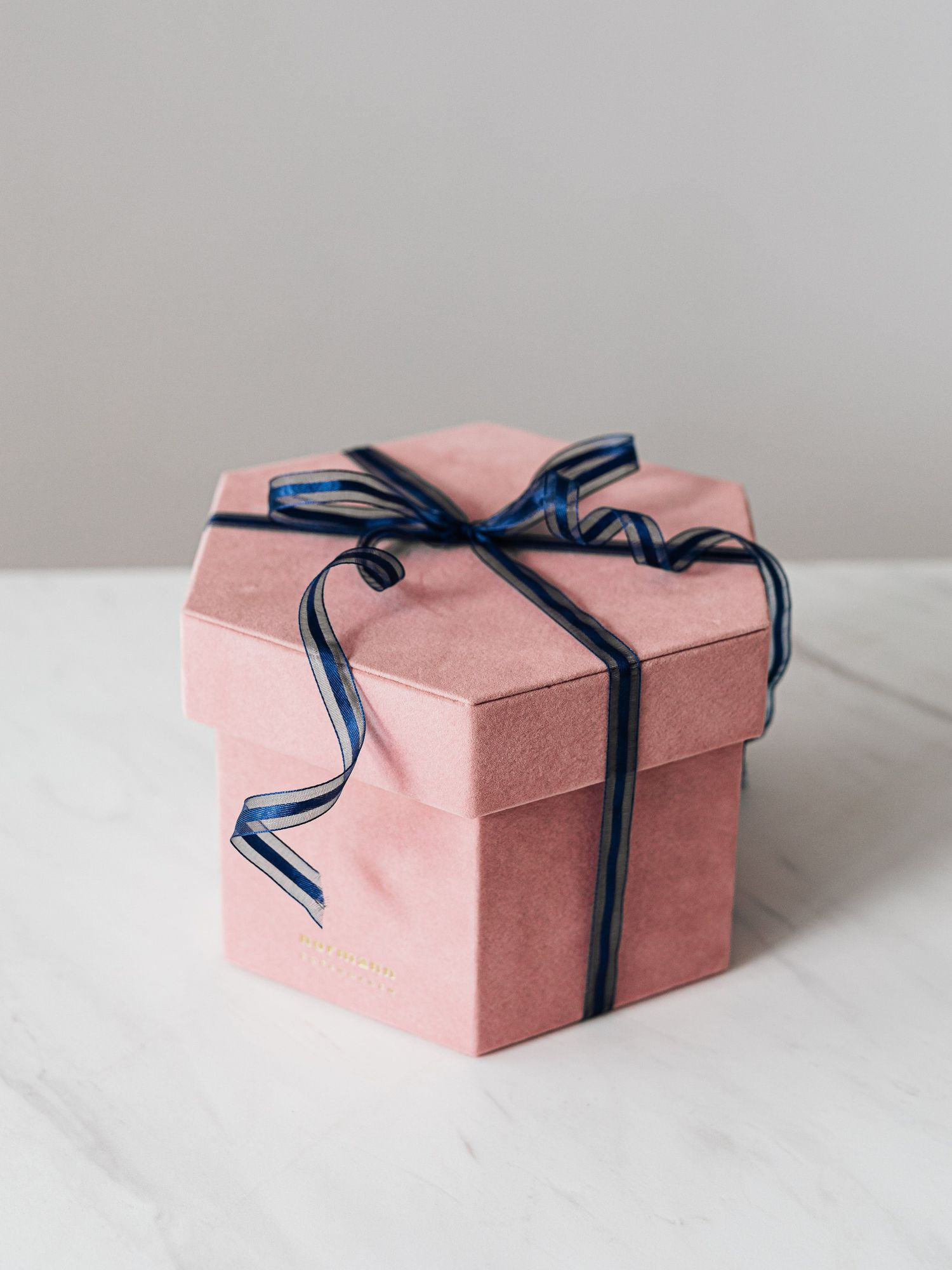 pink gift box with navy blue bow