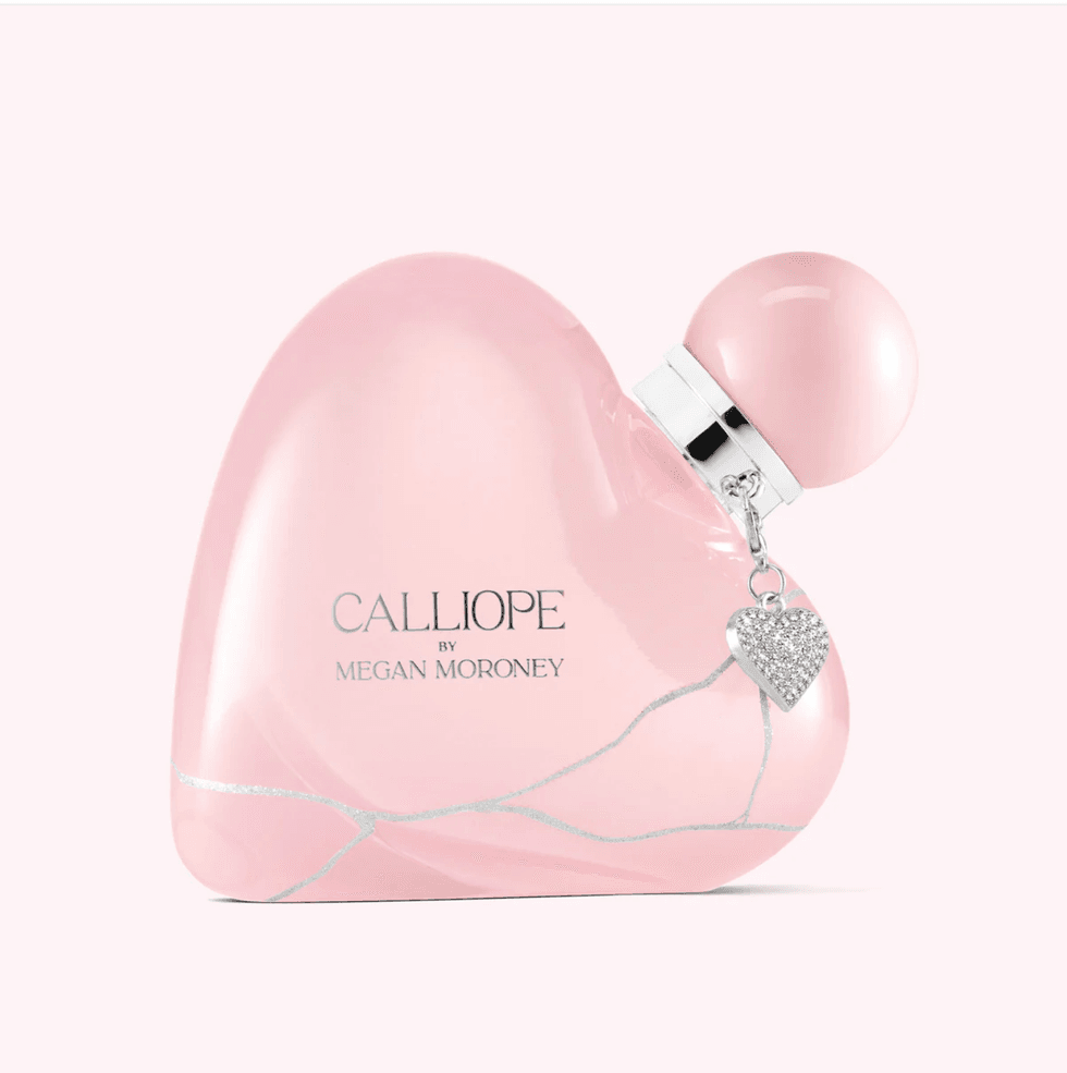 Pink heart-shaped perfume bottle with a silver heart charm and round cap.