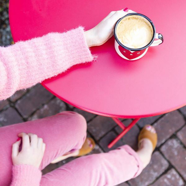 pink outfit sipping coffee