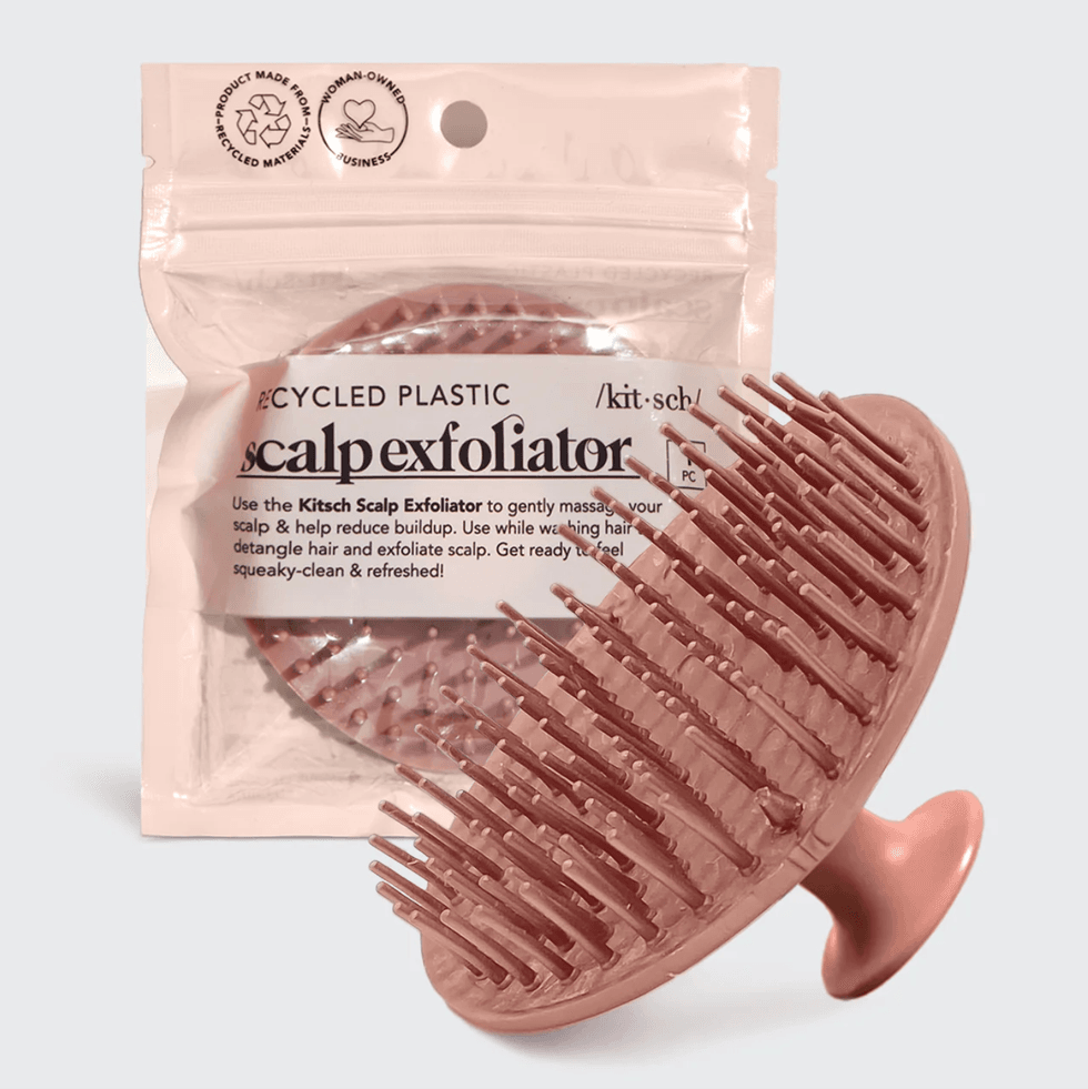 Pink scalp exfoliator in packaging, made from recycled plastic.