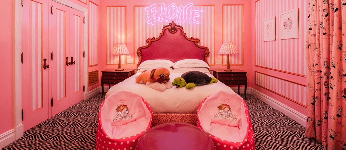 Pink-themed room with bed, plush toys, zebra carpet, and "ELOISE" neon sign.
