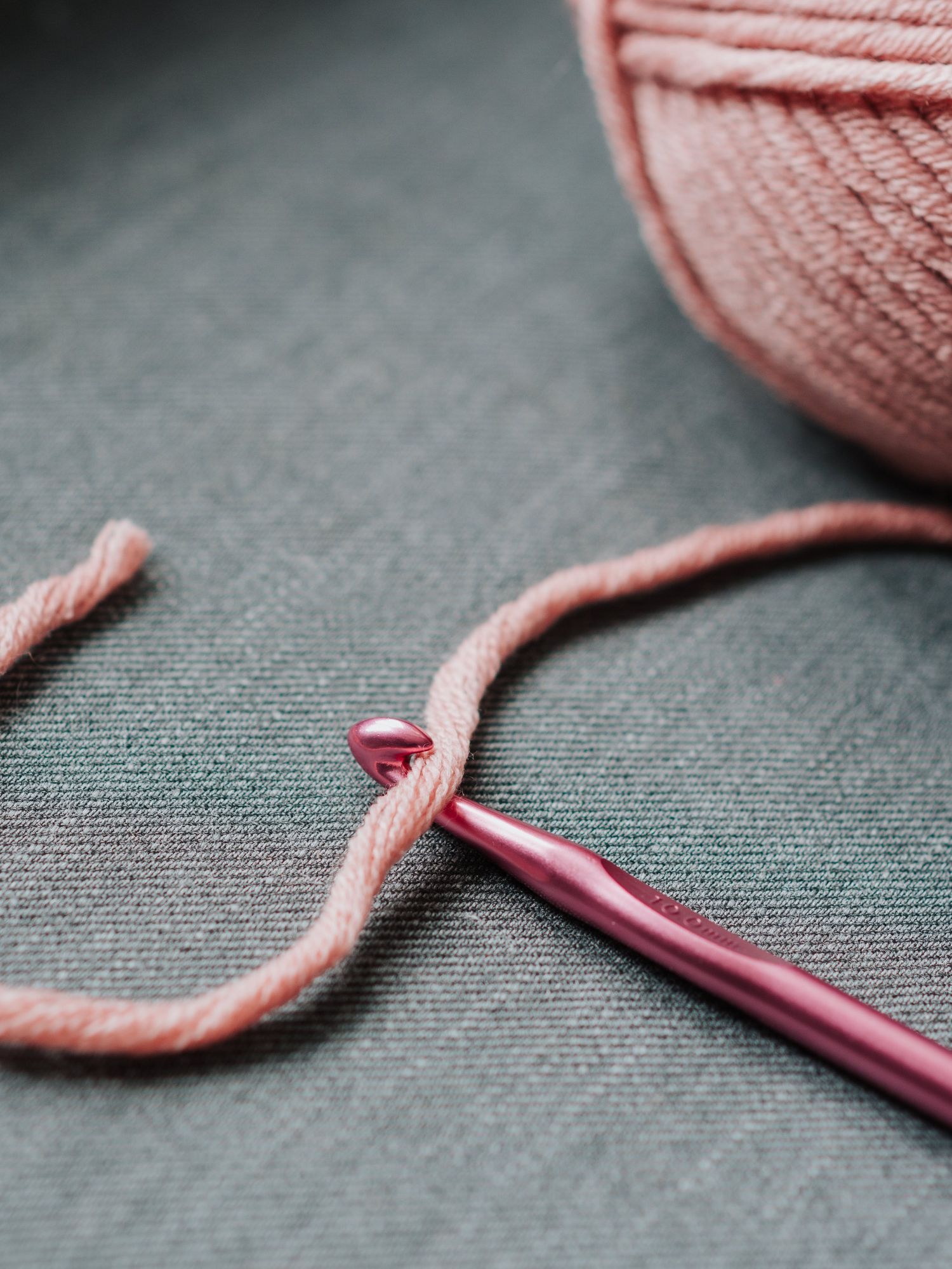 pink yarn on a knitting hook