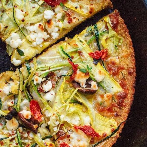 pizza with tomatoes, cheese, olives, and squash