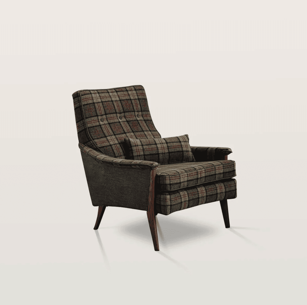 Plaid upholstered armchair with wooden legs on a white background.