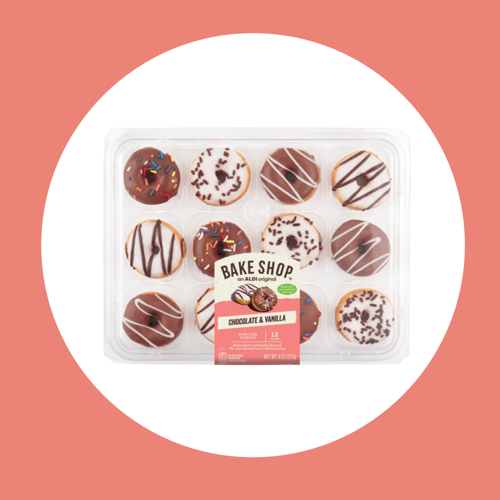 Plastic tray of 12 mini chocolate and vanilla donuts with sprinkles and drizzle designs.
