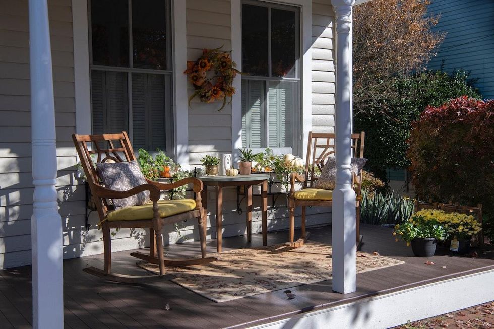 porchscape with rocking chairs and a table