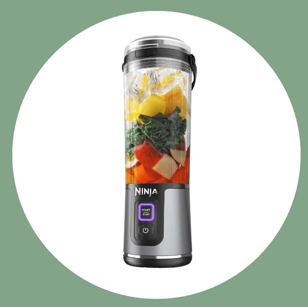 Portable blender with fruits and vegetables inside, ready to blend.