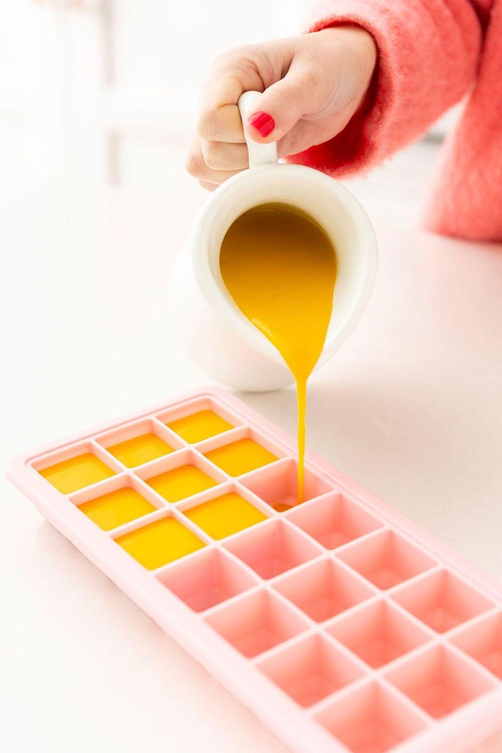 pouring soup into ice tray