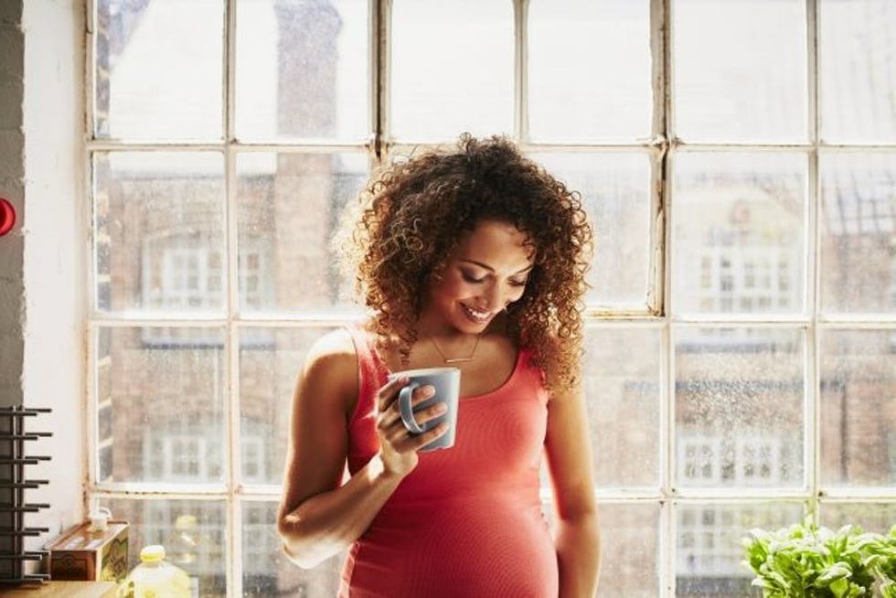 pregnant woman drinking coffee