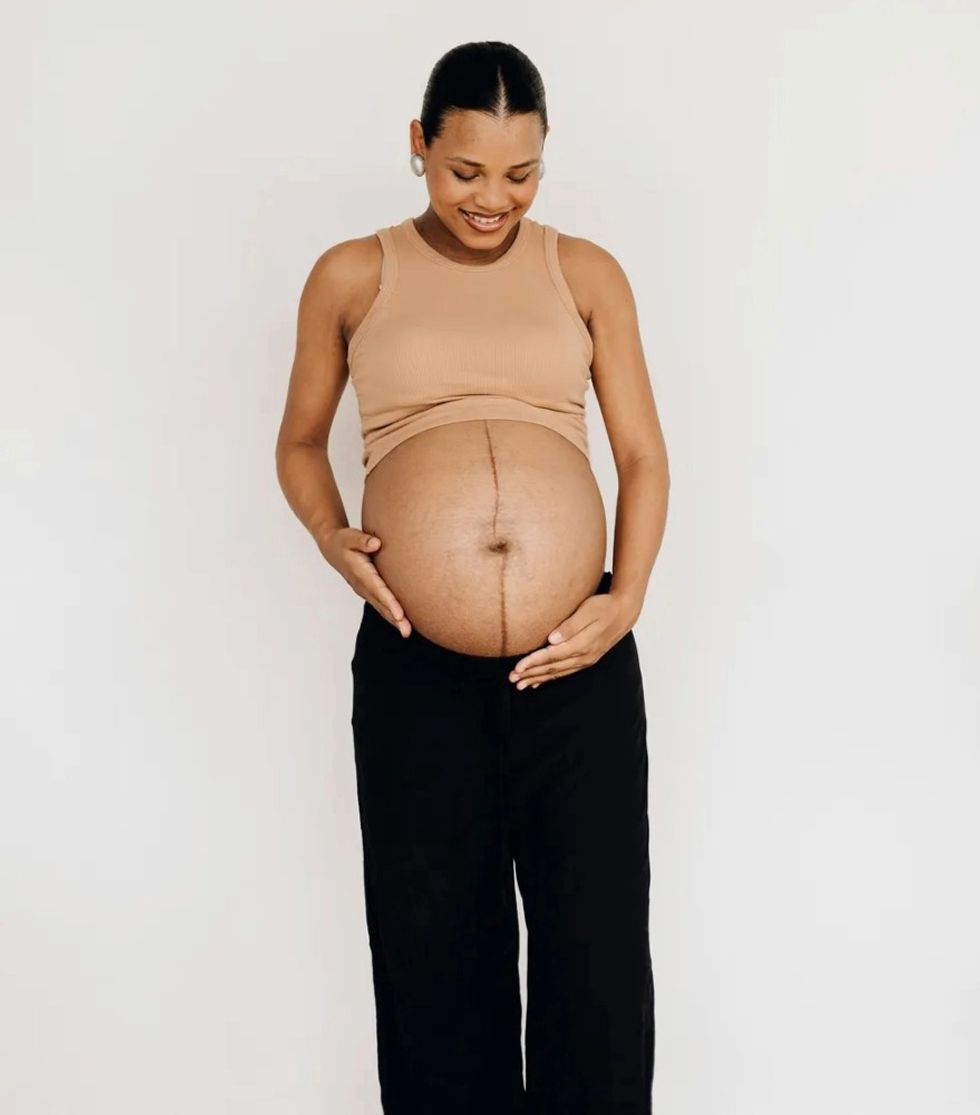 pregnant woman holding her baby bump