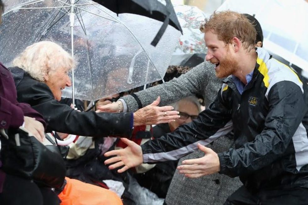 Prince Harry hugs old woman