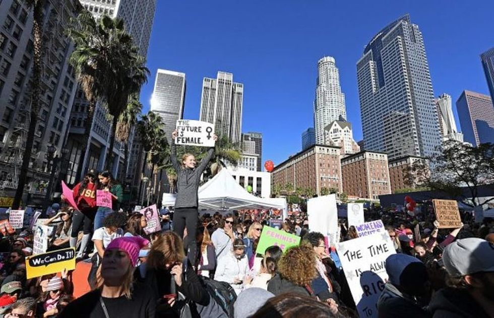 Protesters march in Los Angeles during the Women's March on January 21, 2017. Tens of thousands of people took to the streets of London, Paris and other cities worldwide Saturday in solidarity with women-led marches in the United States, opposed to President Donald Trump the day after his inauguration. / AFP / Angela Weiss (Photo credit should read ANGELA WEISS/AFP/Getty Images)