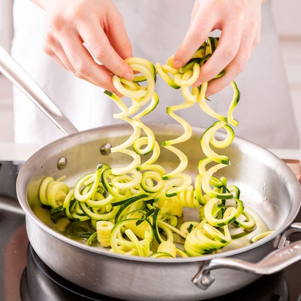 putting the zoodles into the water to cook