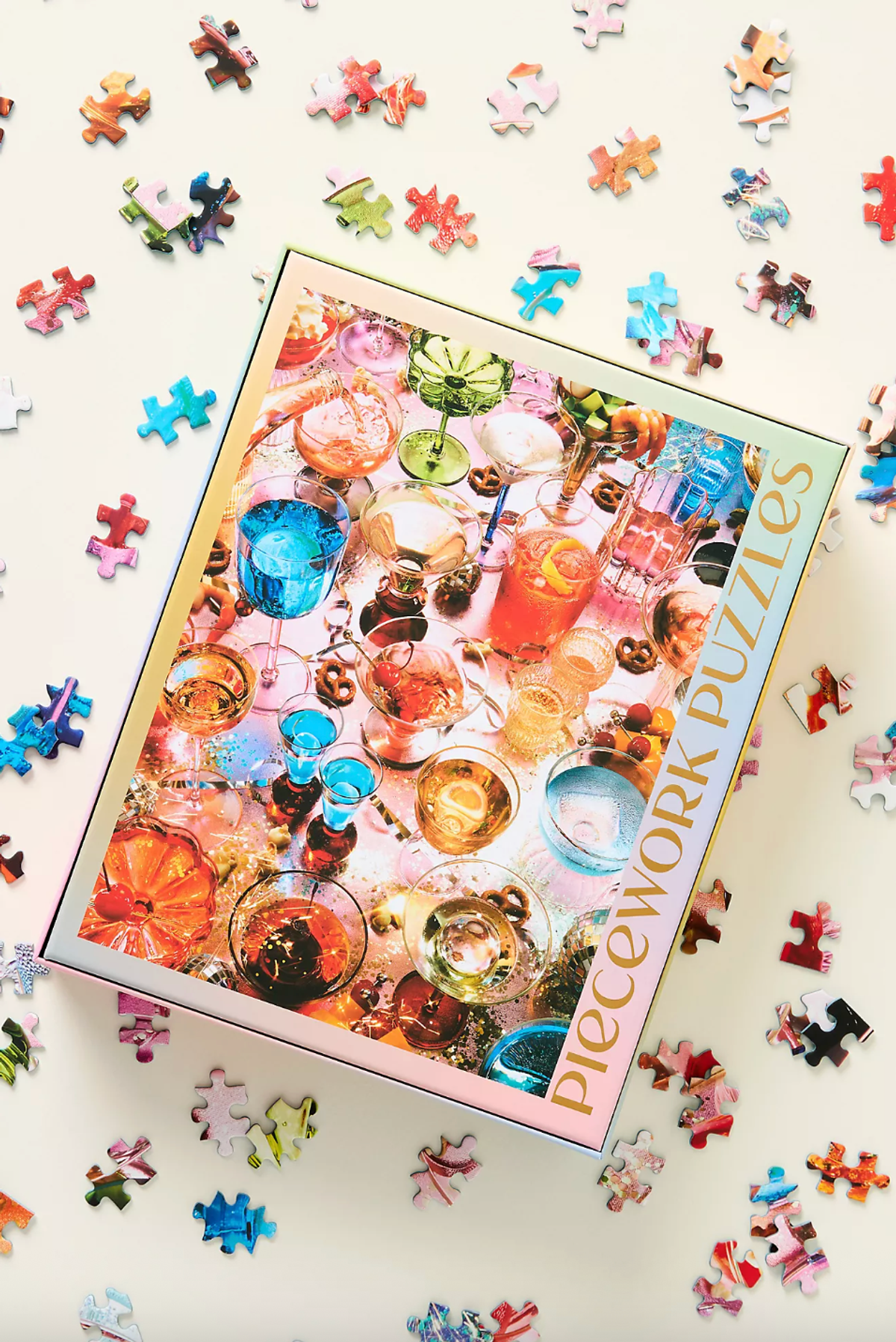 Puzzle box showing colorful drinks, surrounded by scattered puzzle pieces.