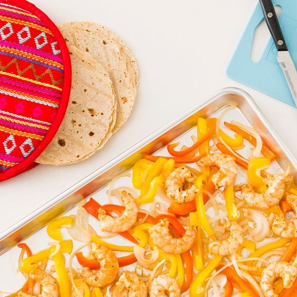 quick keto dinner ideas shown on a cooking sheet with yellow and orange bell peppers, onions, and shrimp.