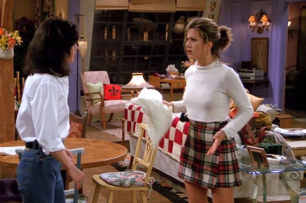 Rachel and Monica stand in their apartment, having a conversation.
