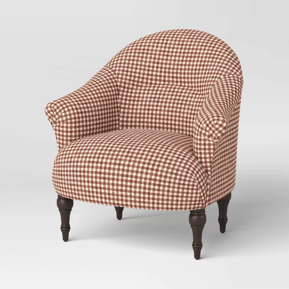 Red and white gingham upholstered chair with dark wooden legs.
