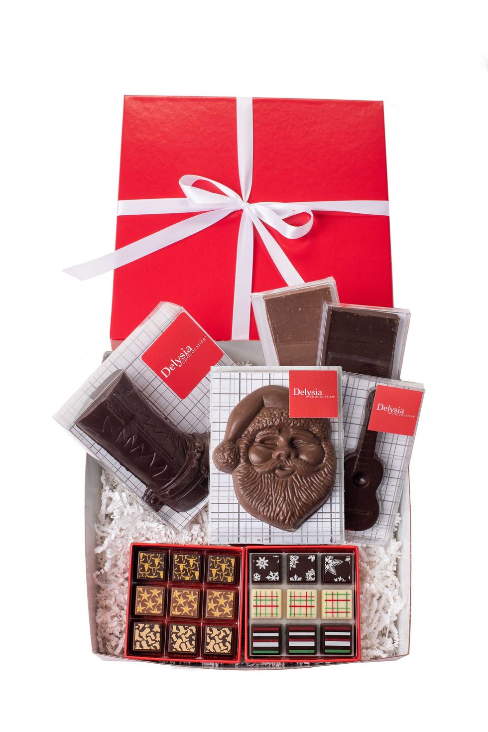 Red gift box with assorted chocolates, including Santa and decorative pieces.