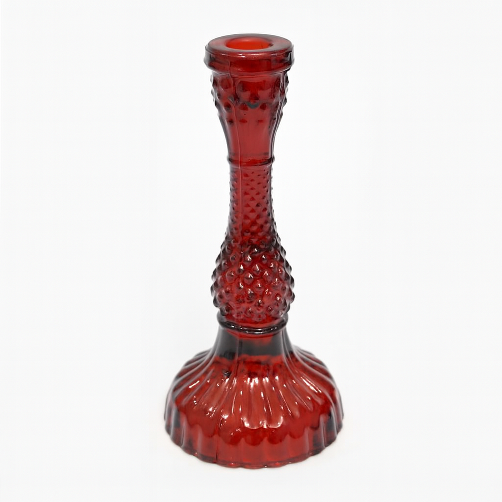 Red glass candlestick holder with textured design on a white background.