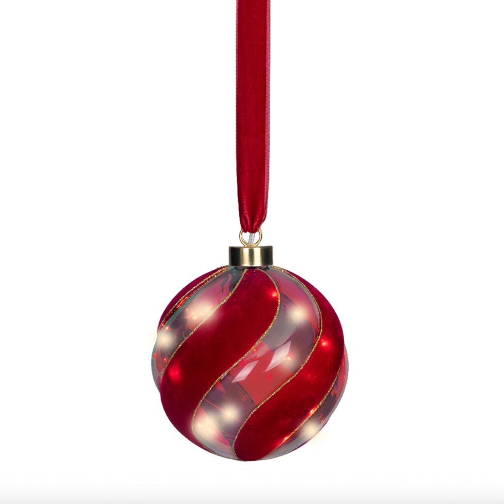 Red glass ornament with swirling velvet stripes and a matching ribbon.