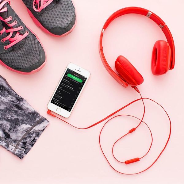 red headphones beside spotify and workout gear