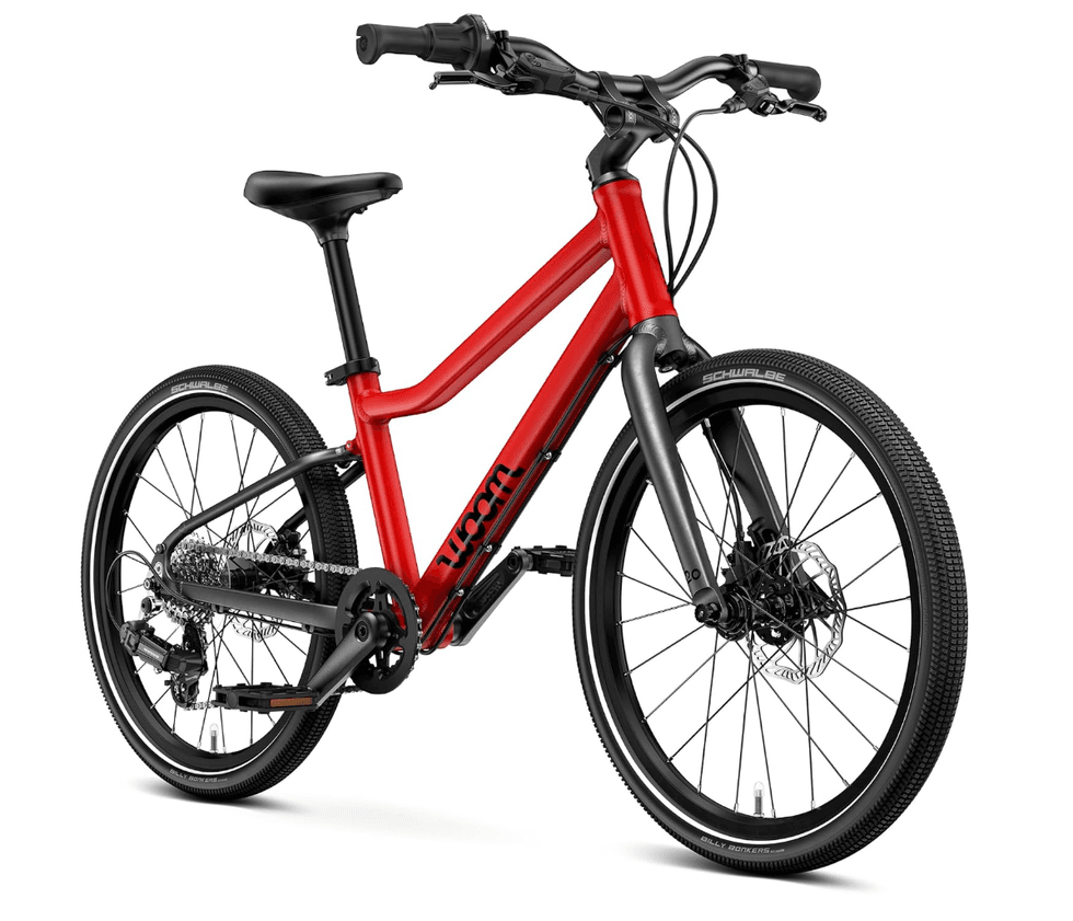 Red hybrid bicycle with black seat and tires, angled view.