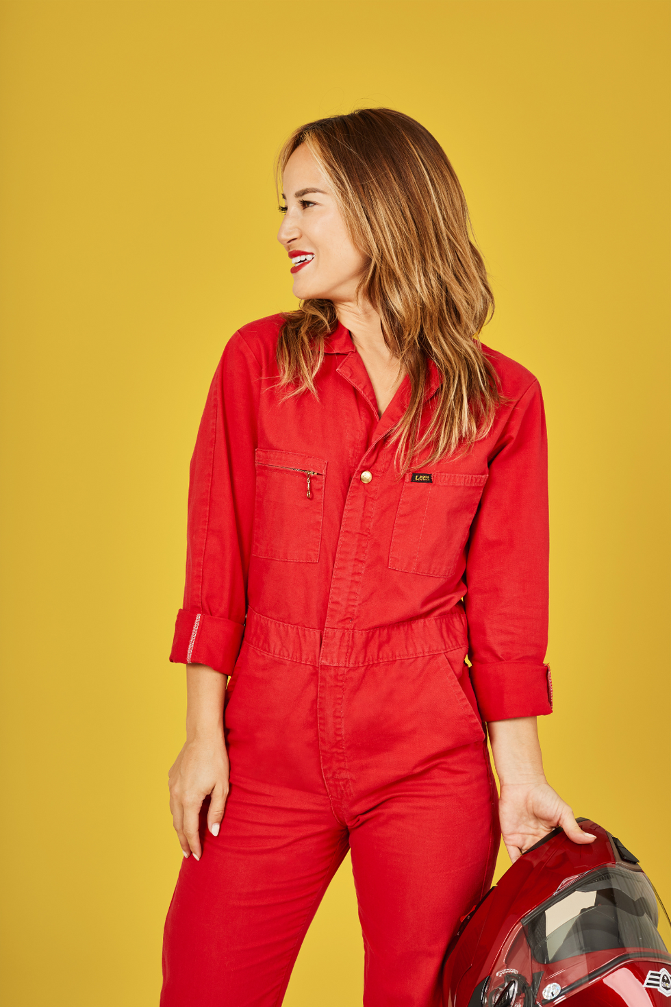 red jumpsuit and red lipstick on a yellow background