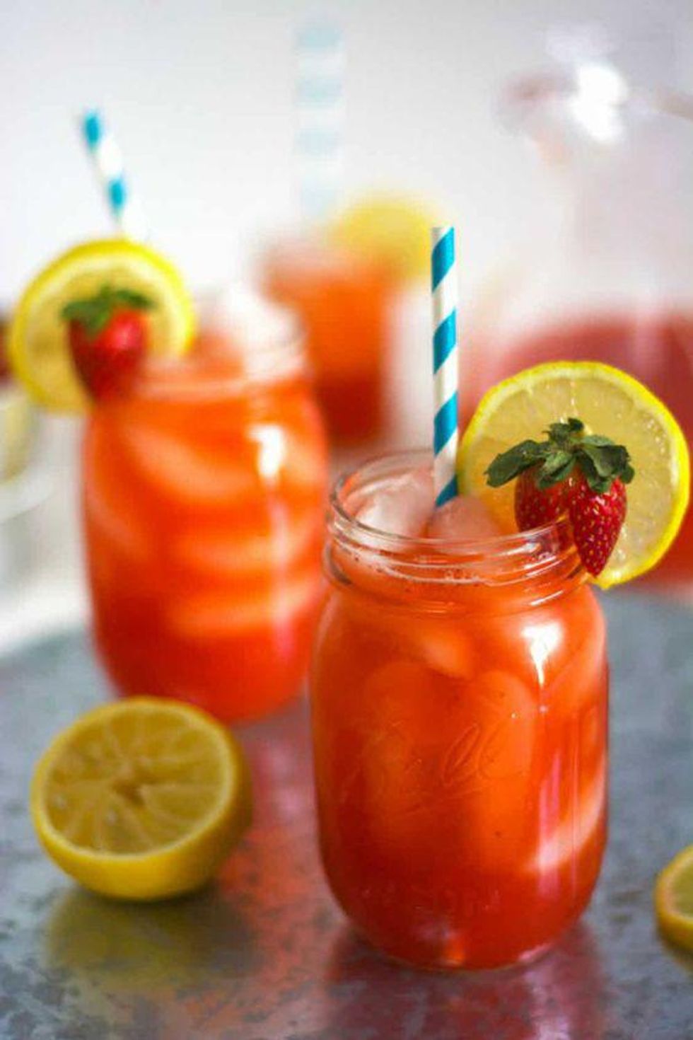 red Skinny Sparkling Strawberry Lemonade in a mason jar with a lemon wedge