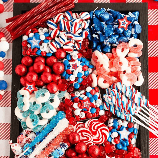 Red, white, and blue candies arranged on a board with a checkered background.