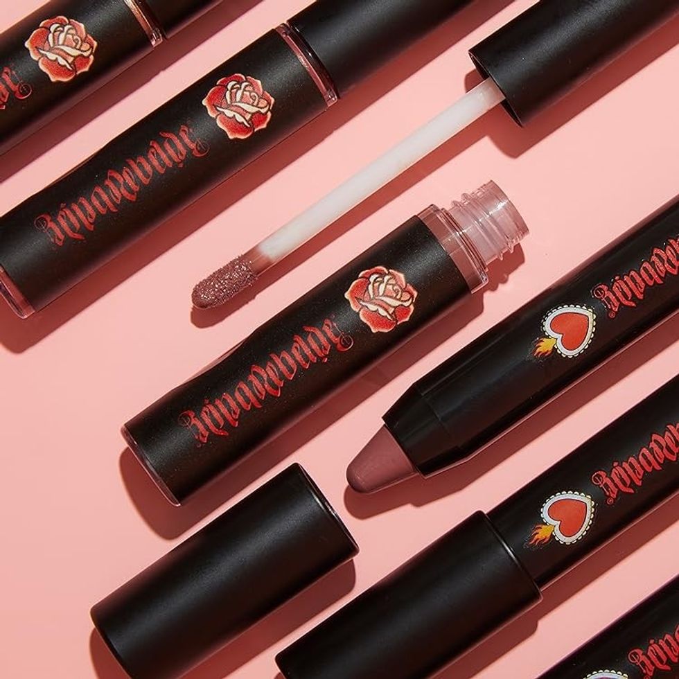 Reina Rebelde lip products are pictured against a pink background.