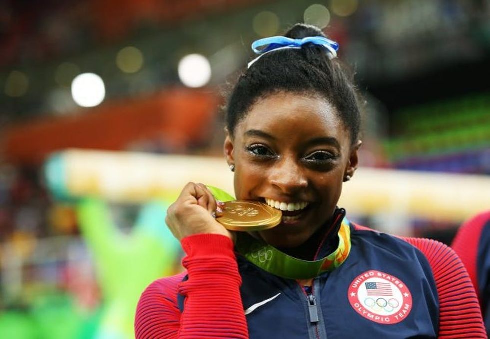 RIO DE JANEIRO, BRAZIL - AUGUST 11: Gold medalist Simone Biles of the United States poses for photographs after the medal ceremony for the Women's Individual All Around on Day 6 of the 2016 Rio Olympics at Rio Olympic Arena on August 11, 2016 in Rio de Janeiro, Brazil. (Photo by Alex Livesey/Getty Images)