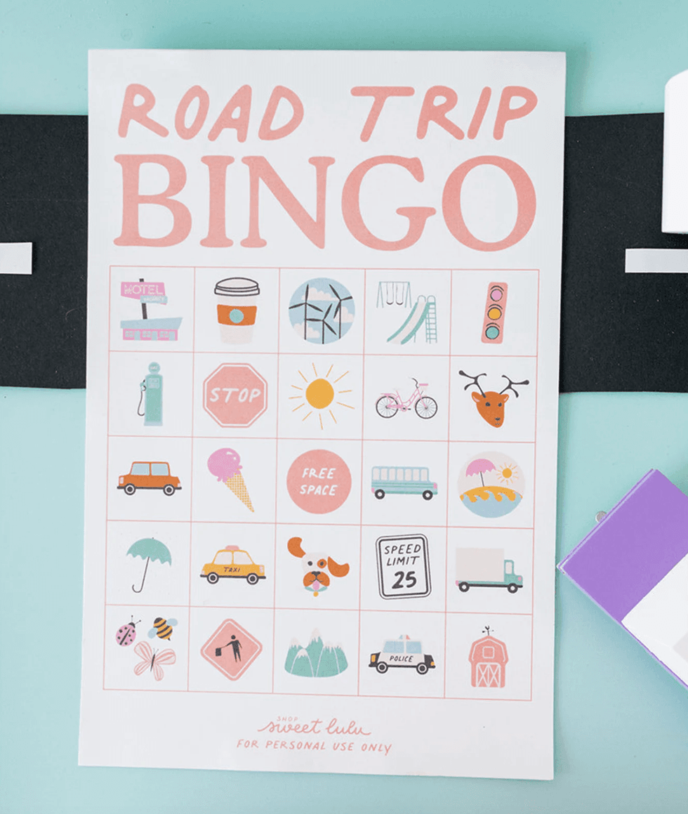 "Road Trip Bingo card with colorful travel-related icons on a light blue background."