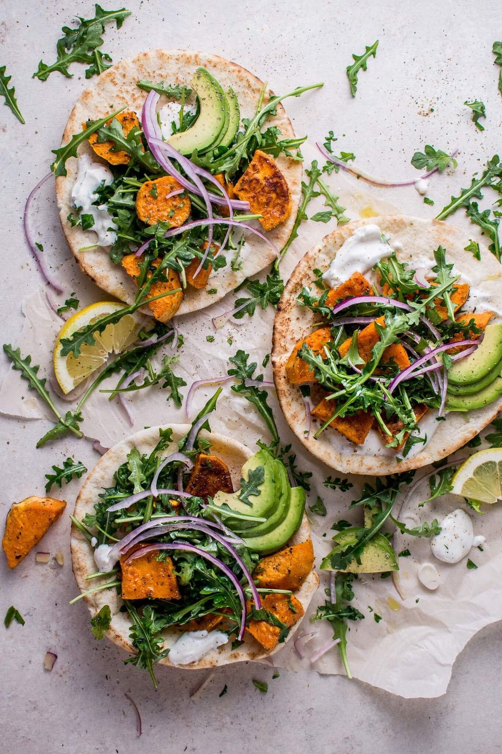Roasted Sweet Potato Pitas with Arugula + Garlic Dressing
