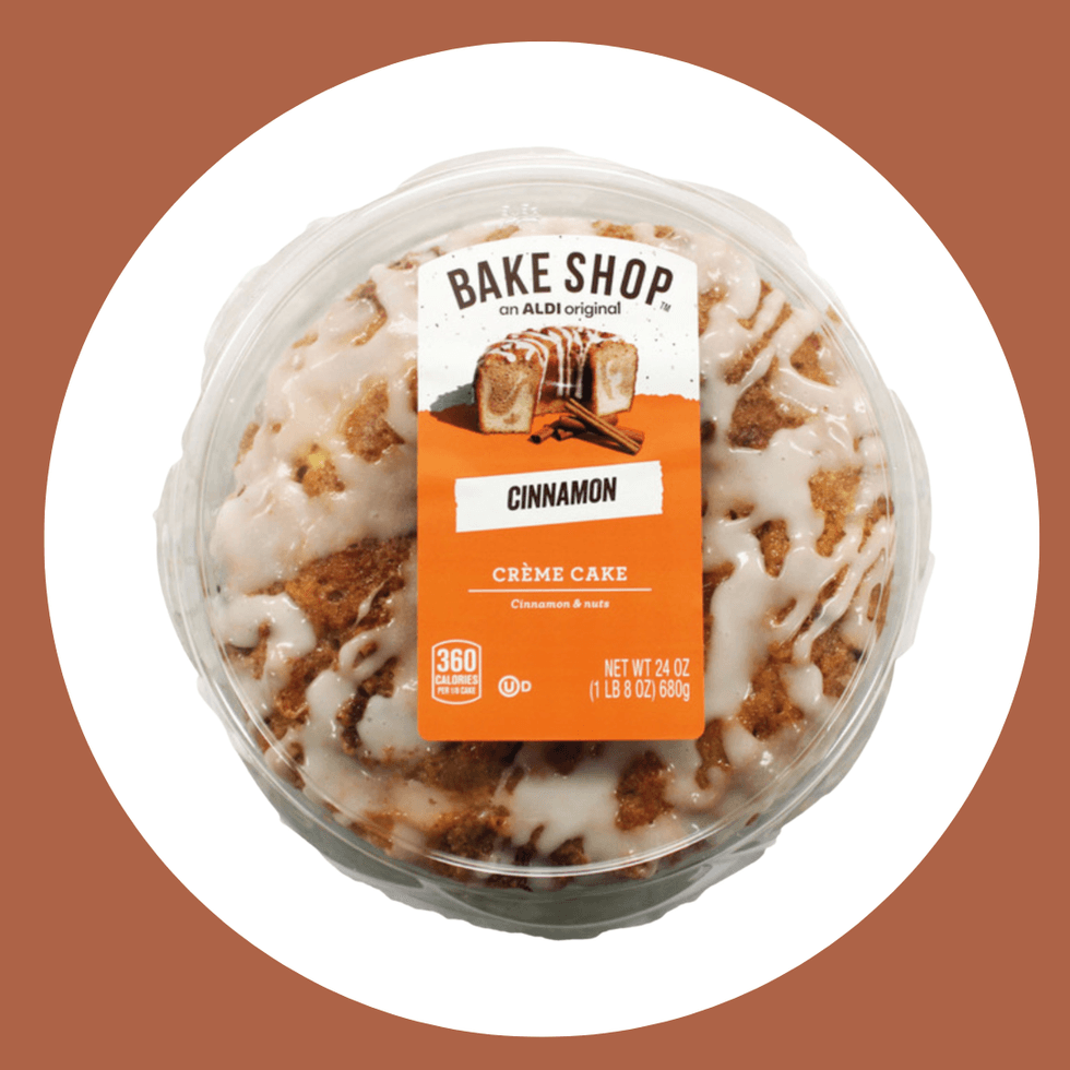 Round cinnamon cr\u00e8me cake in clear packaging, labeled "Bake Shop" with frosting drizzle.