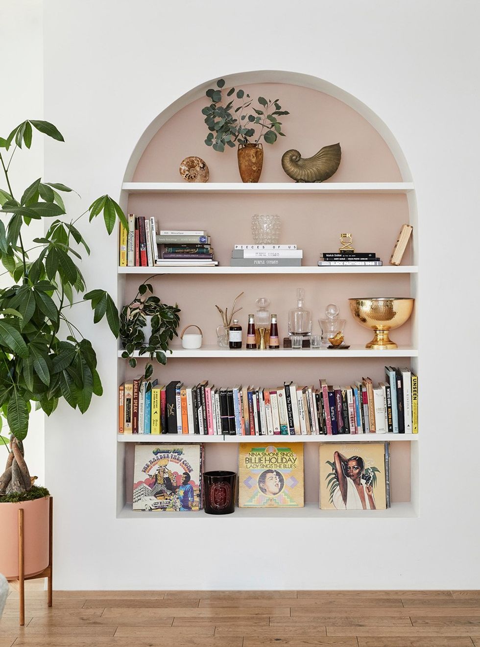 rounded built-in bookshelf with decor