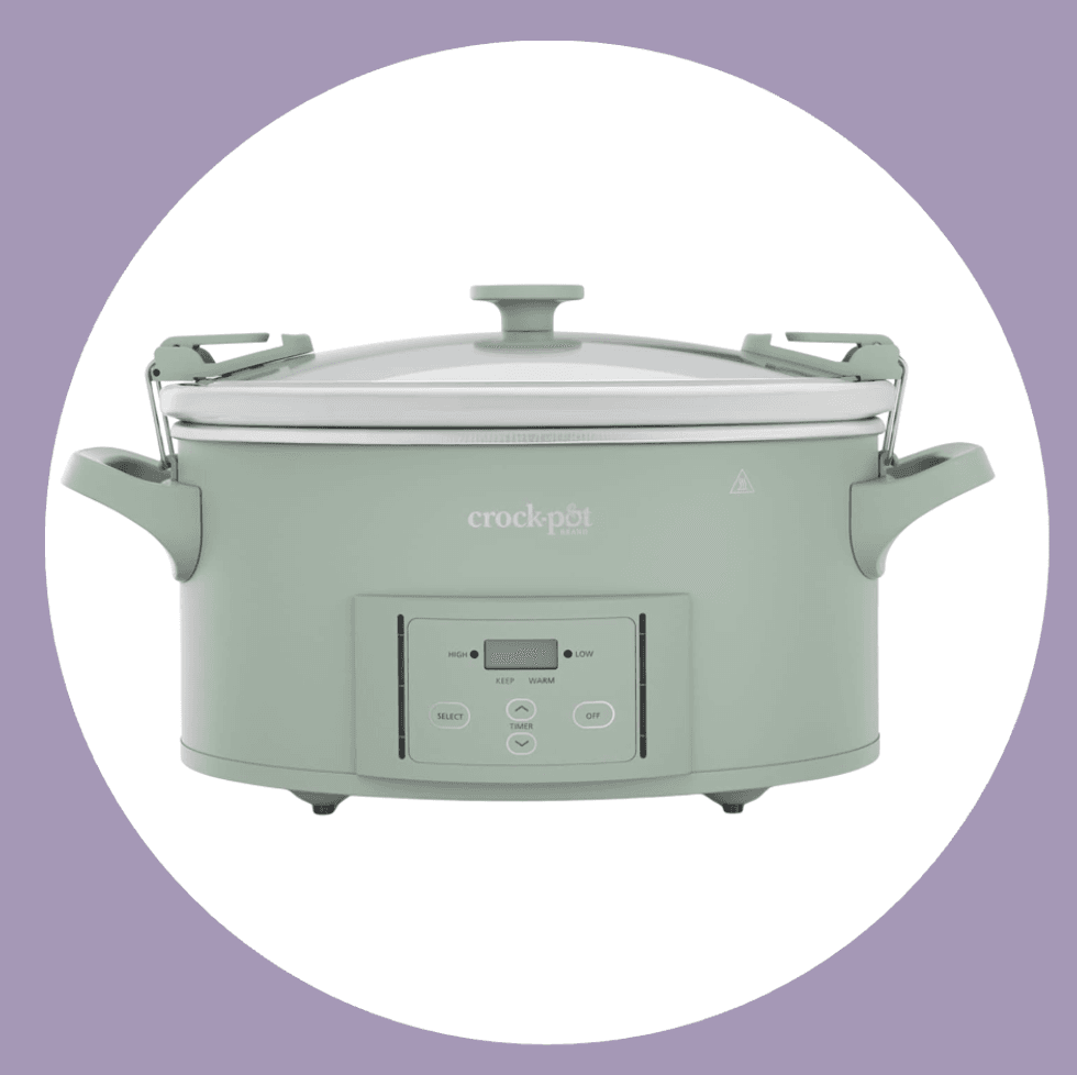 Sage green Crock-Pot with digital display and latch handles on a purple background.