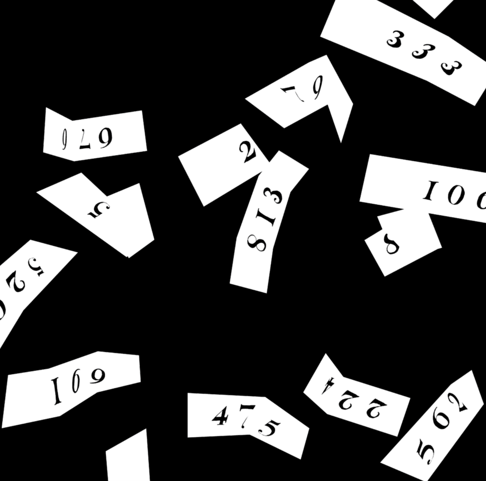 Scattered white paper pieces with black numbers on a black background.