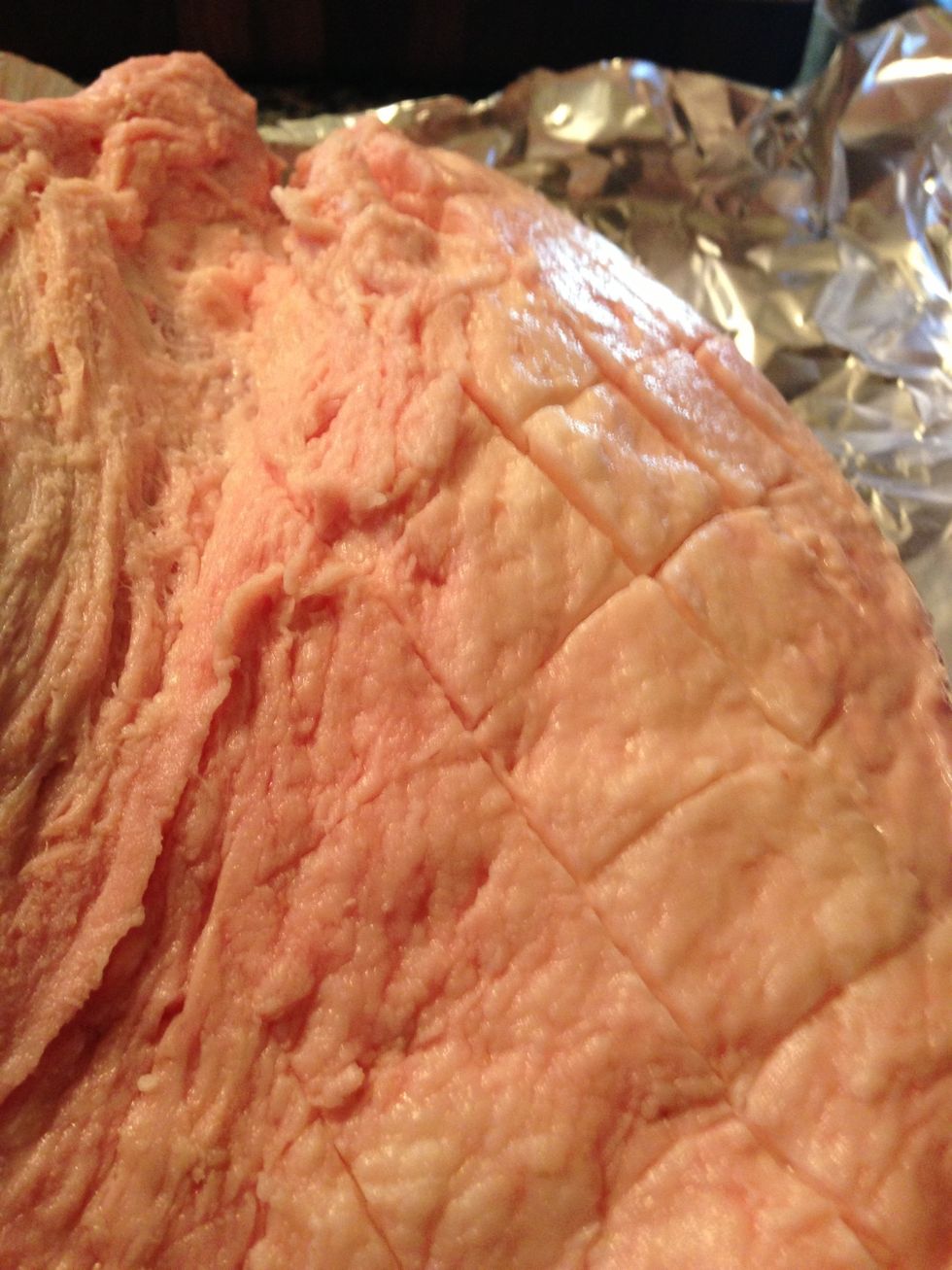 Score the fat cap with a very sharp knife. I cut deeper into heavy chunks of fat to create more surface area for the rub, which adds more flavor later on.