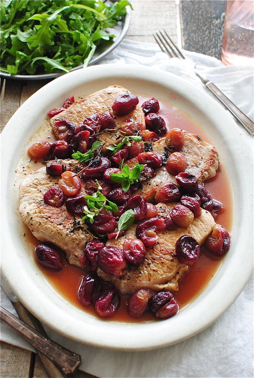 Seared Pork with Roasted Grapes on a white bowl