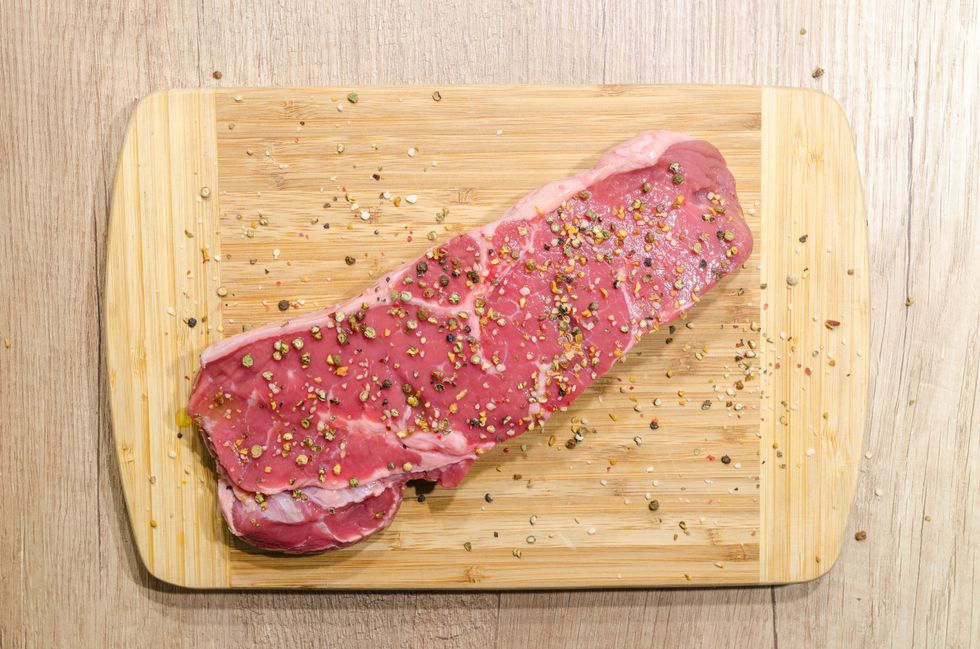 seasoned steak cut pictured from above on a cutting board