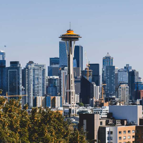 Seattle skyline with the Space Needle against a clear blue sky.