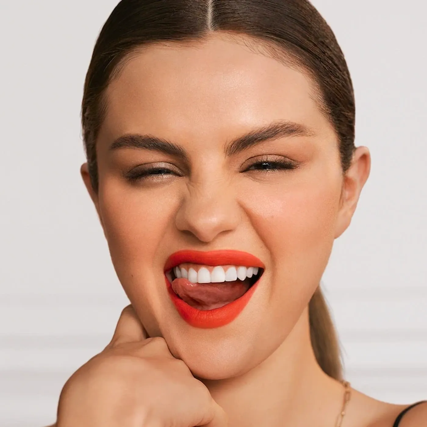 Selena Gomez wearing red lipstick from Rare Beauty