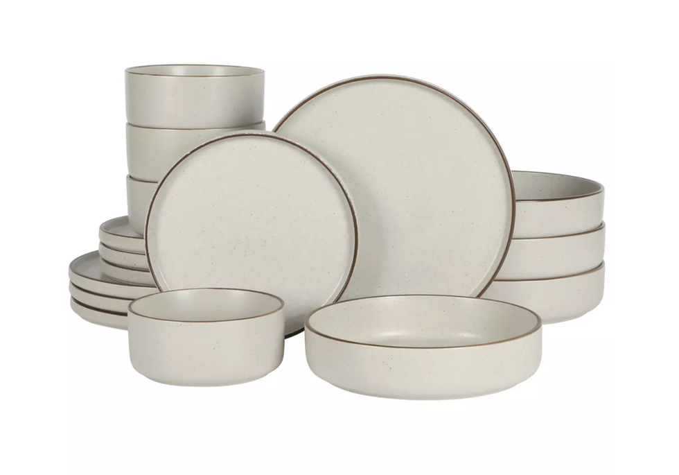 Set of cream-colored stoneware bowls and plates with brown rims.