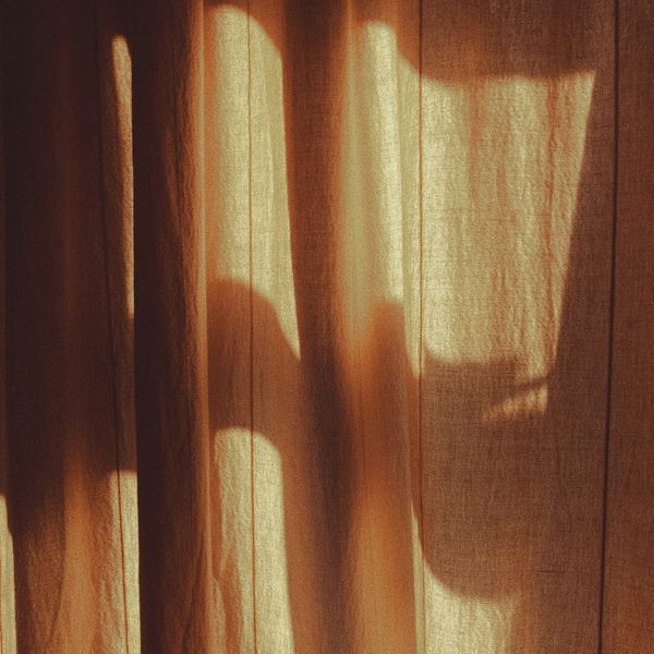 shadow of a person's hand on a curtain
