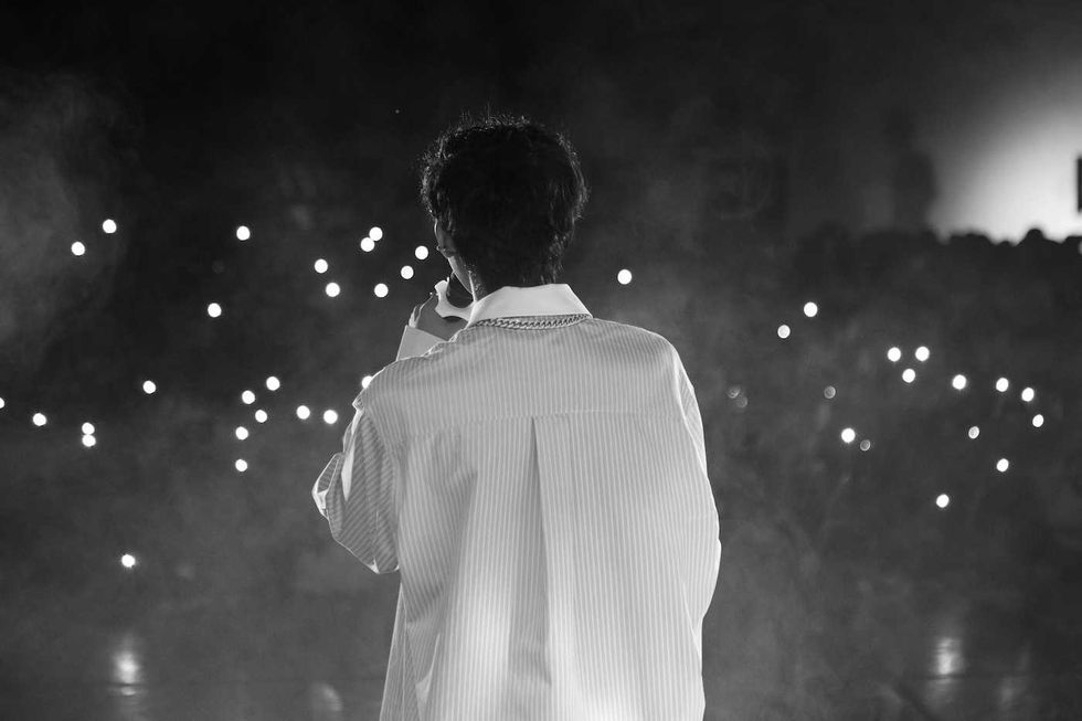 singer in a black and white photo with a white shirt