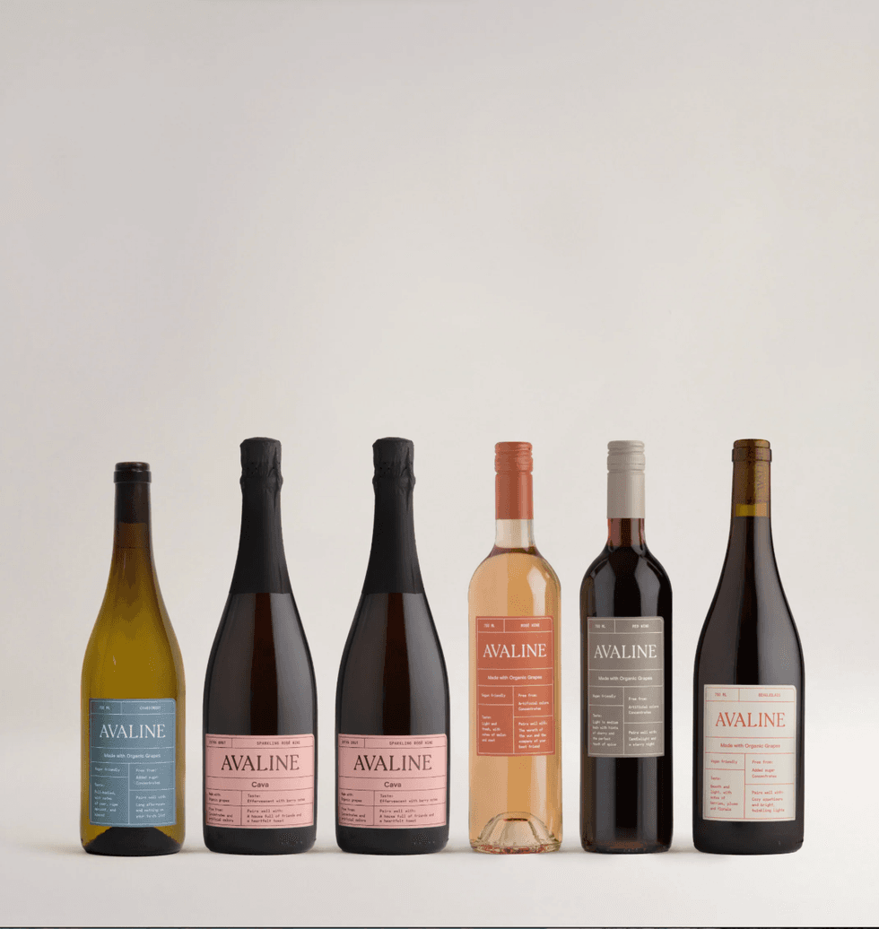 Six Avaline wine bottles with varying labels and colors against a plain background.
