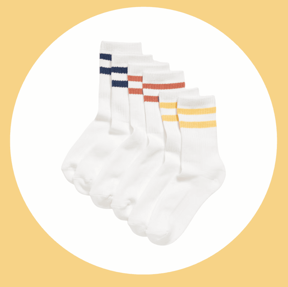 Six white socks with colored stripes: blue, red, and yellow, on a round background.