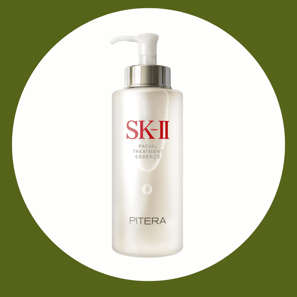 SK-II Facial Treatment Essence bottle with pump, white and silver on a green circle background.