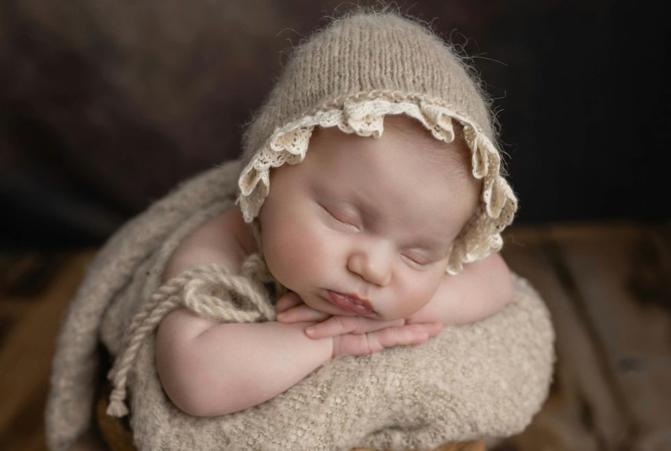 sleeping baby in a bonnet