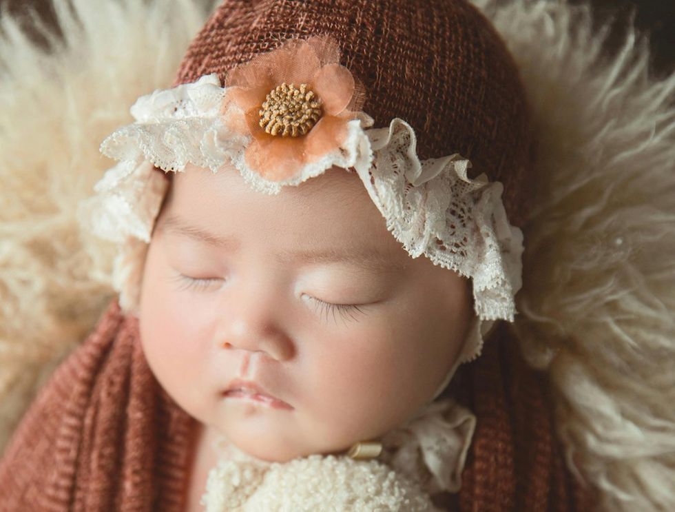 sleeping baby in a bonnet